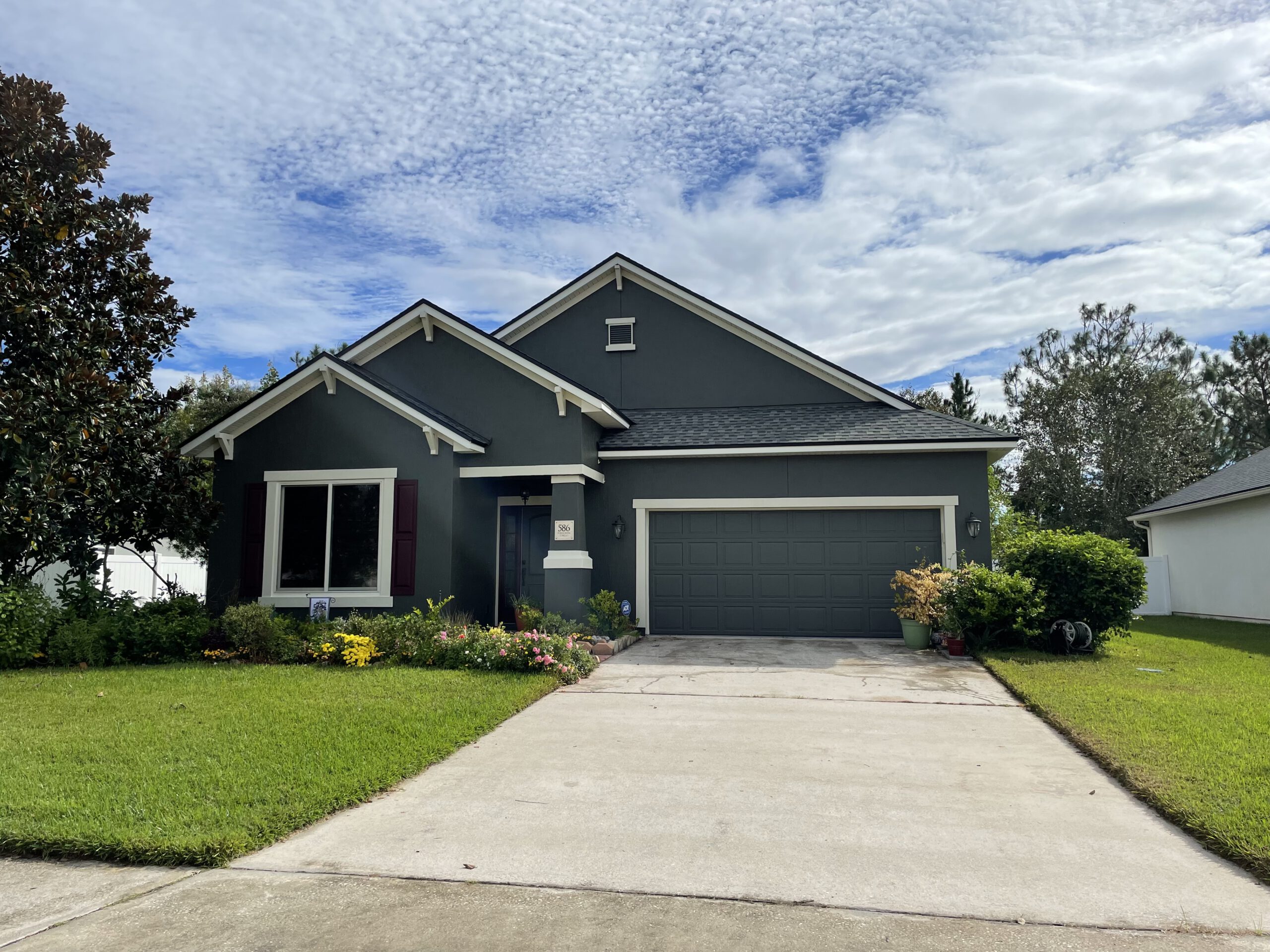 A beautiful, dark blue home painted by Dream Painters in Palm Coast and Ormond Beach.