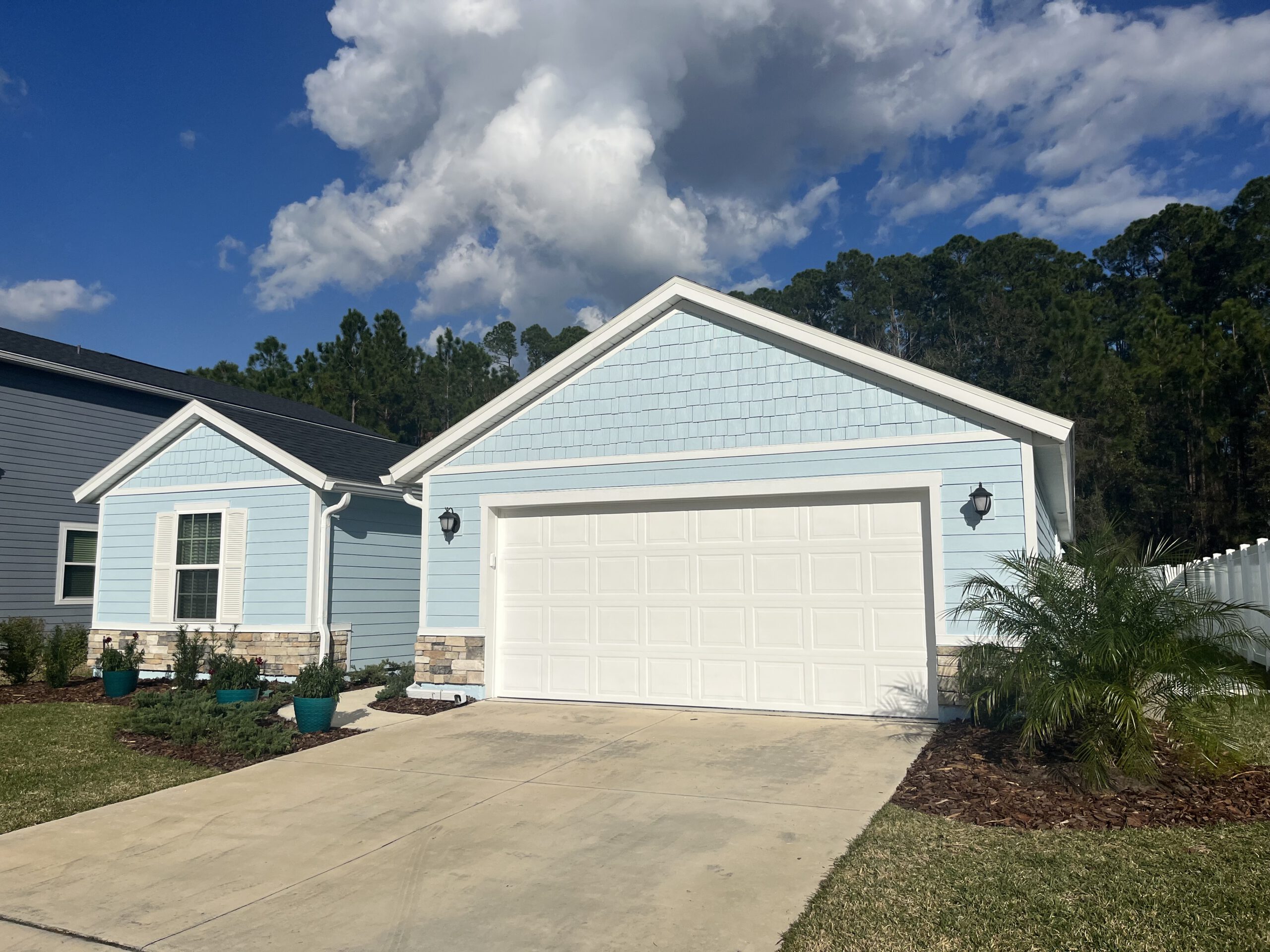 A beautiful, light blue house painted by Dream Painters in Palm Coast and Ormond Beach.