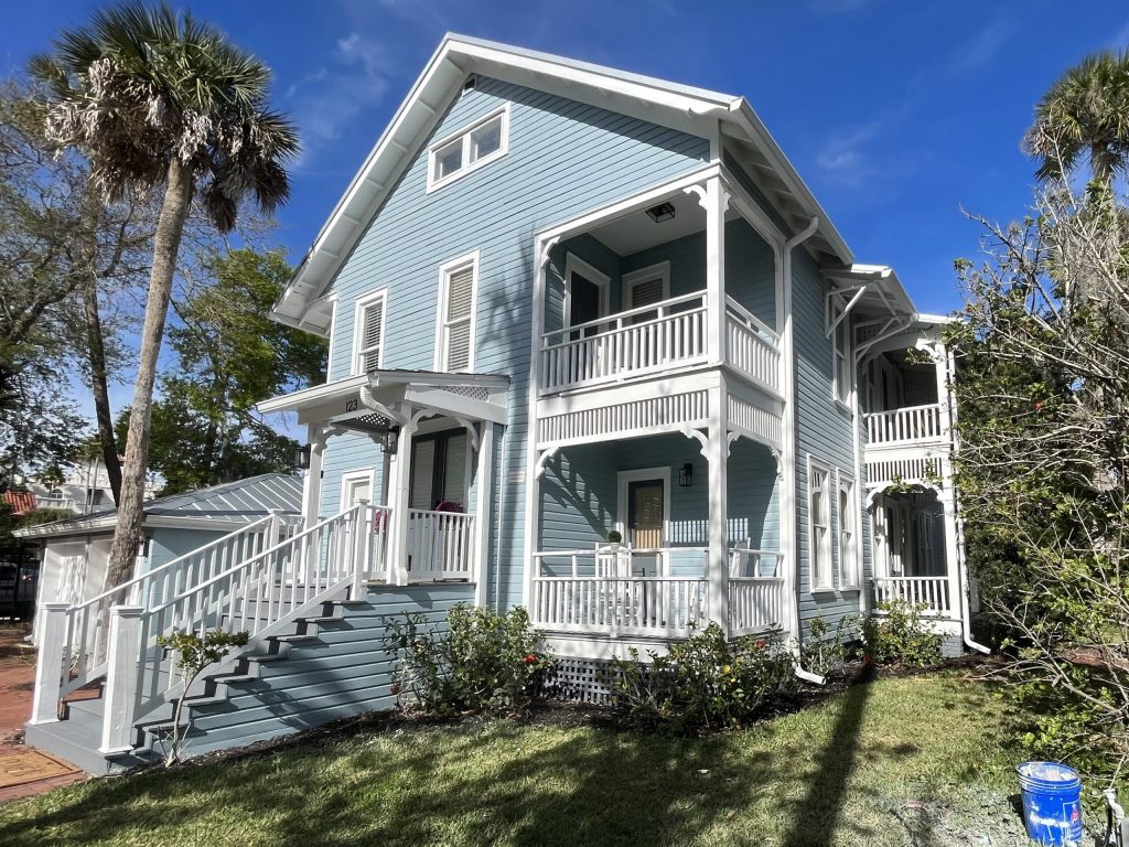 A large two story house painted light blue by Dream Painters in Palm Coast and Ormond Beach.